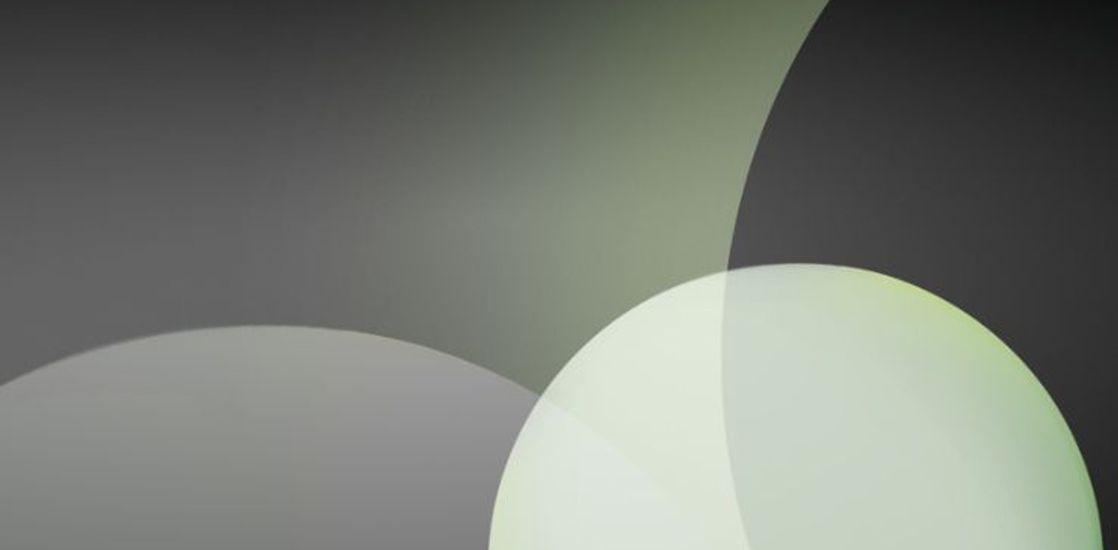 A minimalist abstract design featuring soft circles and gradients in shades of green and gray.