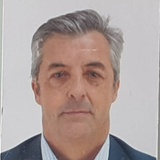 Portrait of a middle-aged man with grey hair and a suit.