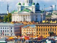 A scenic view of Helsinki Cathedral overlooking a bustling market square and harbor