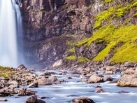 A picture of "Gufufoss" which is a waterfall located in Iceland, represents the IE Alumni Iceland Club