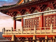 A vibrant photo of a traditional red and gold decorated Asian temple with intricate designs, set against a clear blue sky.