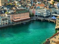 Aerial view of a city with historic buildings and a river running through it.