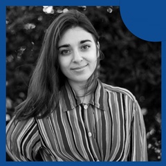 A portrait of a smiling woman wearing a striped shirt, set against a floral background with a circular blue frame.