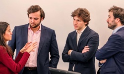 A group of four young professionals engaged in a discussion.