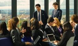 A diverse group of professionals engaged in a discussion in a modern office setting.