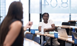 A focused student listens intently during a classroom discussion.