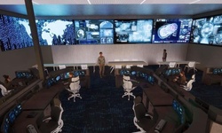 A modern control room equipped with multiple screens displaying data and maps.