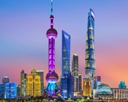 A stunning skyline view of Shanghai at sunset featuring iconic skyscrapers.