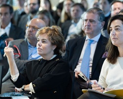 A group of people attentively listening during a conference or seminar.