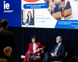 A conference setting with speakers discussing in front of an audience at IE University.