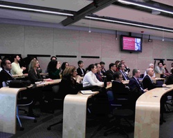 A group of people attending a presentation in a modern conference room.