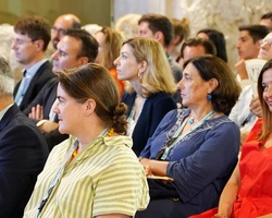 A diverse group of people sitting and listening attentively at an event.