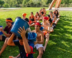 A group of young people participating in a fun outdoor water game.