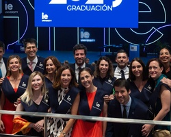 A group of graduates posing for a photo at a graduation ceremony.