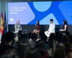 A panel discussion featuring four speakers at an event focused on the impact of IE's vision, history, and mission.