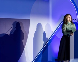 A speaker presenting at an event for IE University.