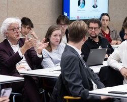 A group of people engaged in a discussion during a meeting.