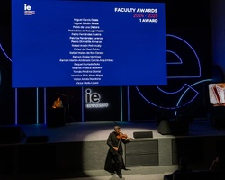 A performer playing a string instrument on stage during an awards ceremony.
