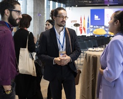 People engaging in a conversation at a conference event.