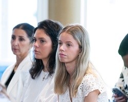 A group of people attentively listening during an event.