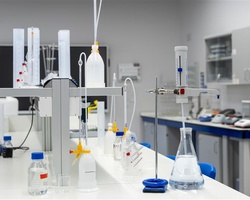 A clean laboratory workspace with various glassware and instruments arranged on a table.