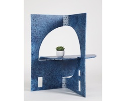 A unique blue artistic shelf with an arch design and a small plant on it.