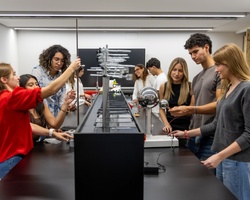 A group of students engaged in a hands-on experiment in a science lab.