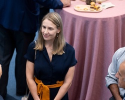 A group of professionals engaged in a conversation at a networking event.