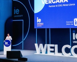 A speaker presenting at a welcome event for IE University.