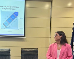 A presentation slide discussing psychological safety and its associated behaviors.