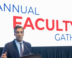 A speaker addressing an audience at an annual faculty gathering.