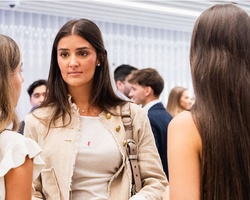 A group of young women engaging in conversation at a social event.