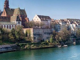 Picture taken of one side of the Rhine river in which the Basel city of Switzerland is at the back as the image that represents the IE Alumni Switzerland club.