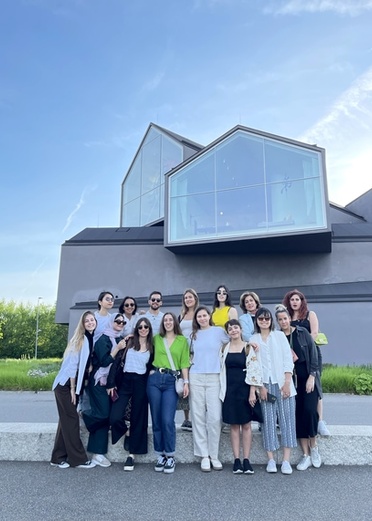 a group of architecture students possing for the camera in front of a modern building