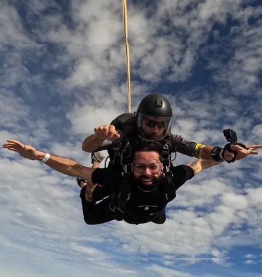 A thrilling tandem skydiving experience captured in mid-air.