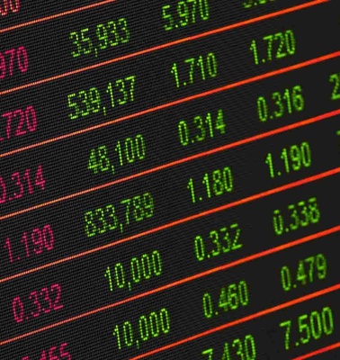 Close-up view of a stock market data screen showing various stock prices in green and red.