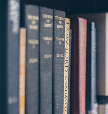 A collection of books arranged on a shelf.