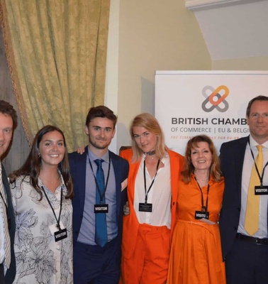 Group of six people posing for a photo at a British Chamber of Commerce event.
