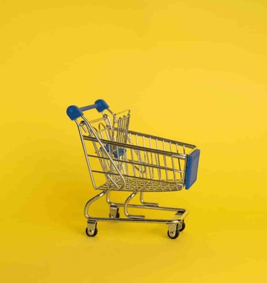A blue shopping cart isolated on a yellow background.