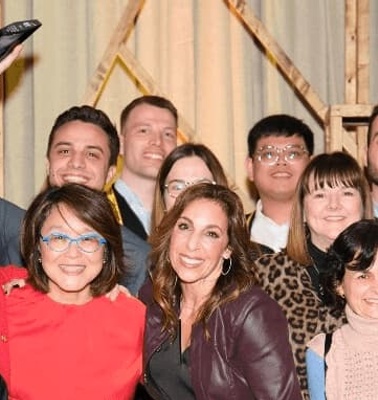 A group of diverse people smiling and posing together at an event.