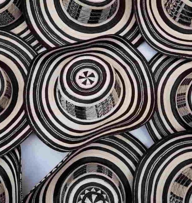 A collection of traditional black and white patterned hats.