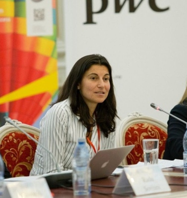 A panel discussion featuring three speakers at a conference.