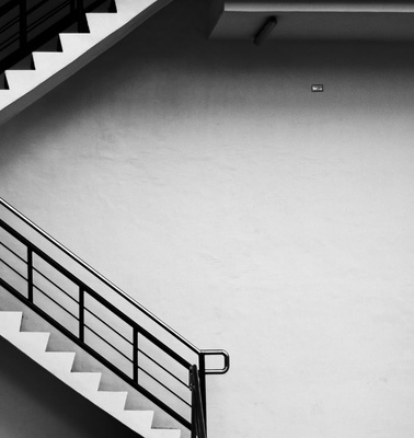 A black and white image of a staircase in a minimalist setting.