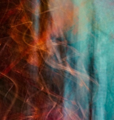 Abstract image showcasing streaks of vibrant colors blending over a dark background.