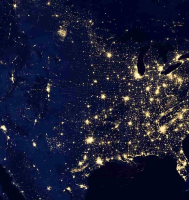 Nighttime satellite view of the United States showing city lights
