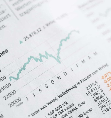 A close-up of financial charts illustrating market trends and data for the Dow Jones and other indexes.