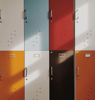 A row of colorful lockers with shadows casting over them, presenting a vibrant and organized appearance.