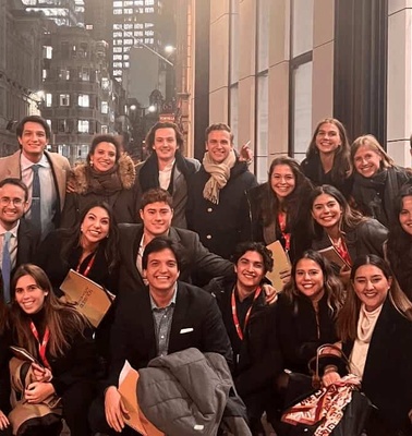 A group of people posing together on a city street.