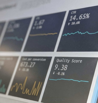 A close-up view of a digital screen displaying various business metrics and analytics charts.
