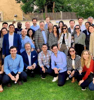 A group of people posing for a photo at an outdoor gathering.